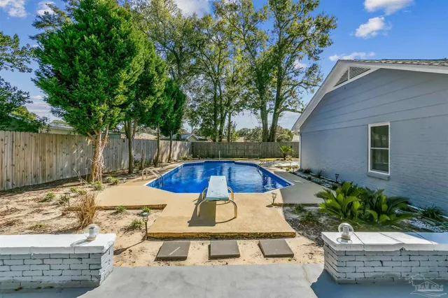 a view of a backyard with swimming pool