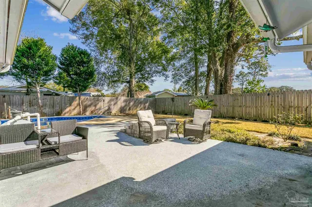 a white bench sitting in the middle of a yard