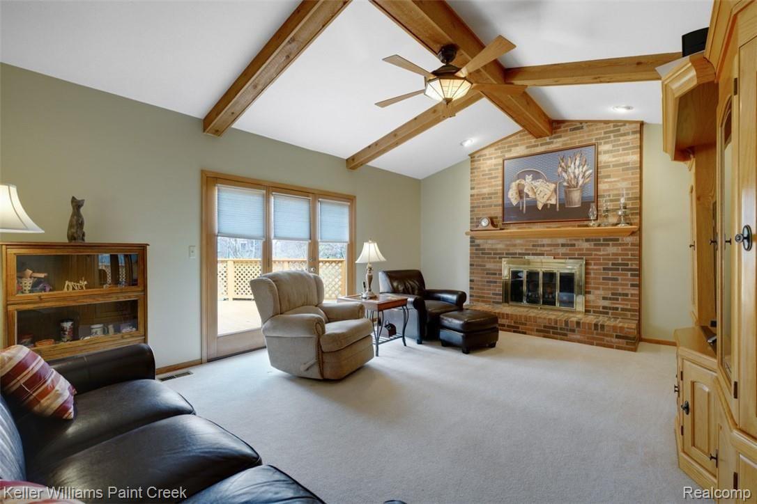 3098 Baypoint Drive Rochester, MI 48309 - Photo 15 of 32 This impressive family room has great design details like vaulted ceiling with beams, brick fireplace and another set of doors leading to the outdoor deck.