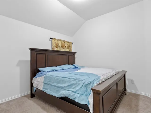 a bedroom with a bed and cabinet