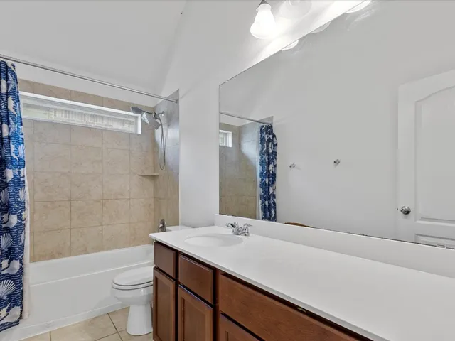 a bathroom with a sink a toilet a shower and a mirror