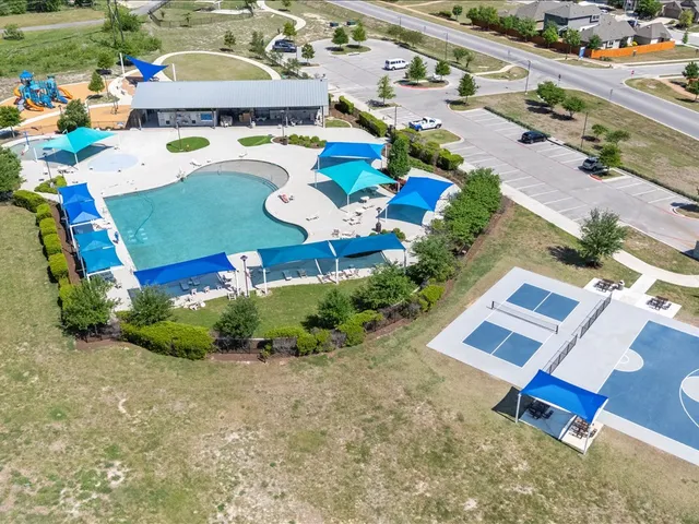 an aerial view of a gaming yard and mountain view in back