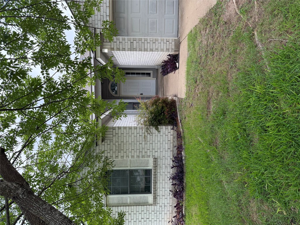 a front view of a house with a garden and yard