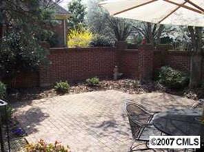 3200 Sharon Road, Unit 1 Charlotte, NC 28211 - Photo 8 of 8 a view of a backyard with plants and brick wall