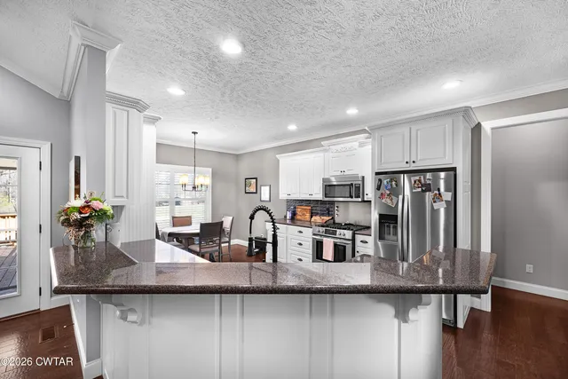 a kitchen with counter top space cabinets and stainless steel appliances