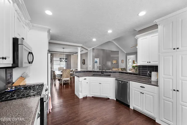 a large kitchen with stainless steel appliances lots of counter top space