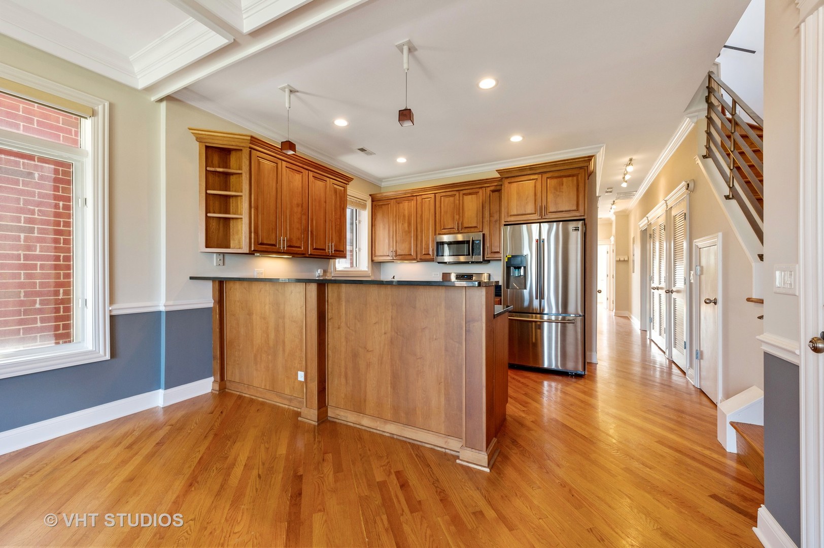 2022 North Wood Street, Unit 3S Chicago, IL 60614 - Photo 4 of 13 a view of a kitchen with stainless steel appliances granite countertop a refrigerator oven a sink dishwasher and wooden cabinets with wooden floor