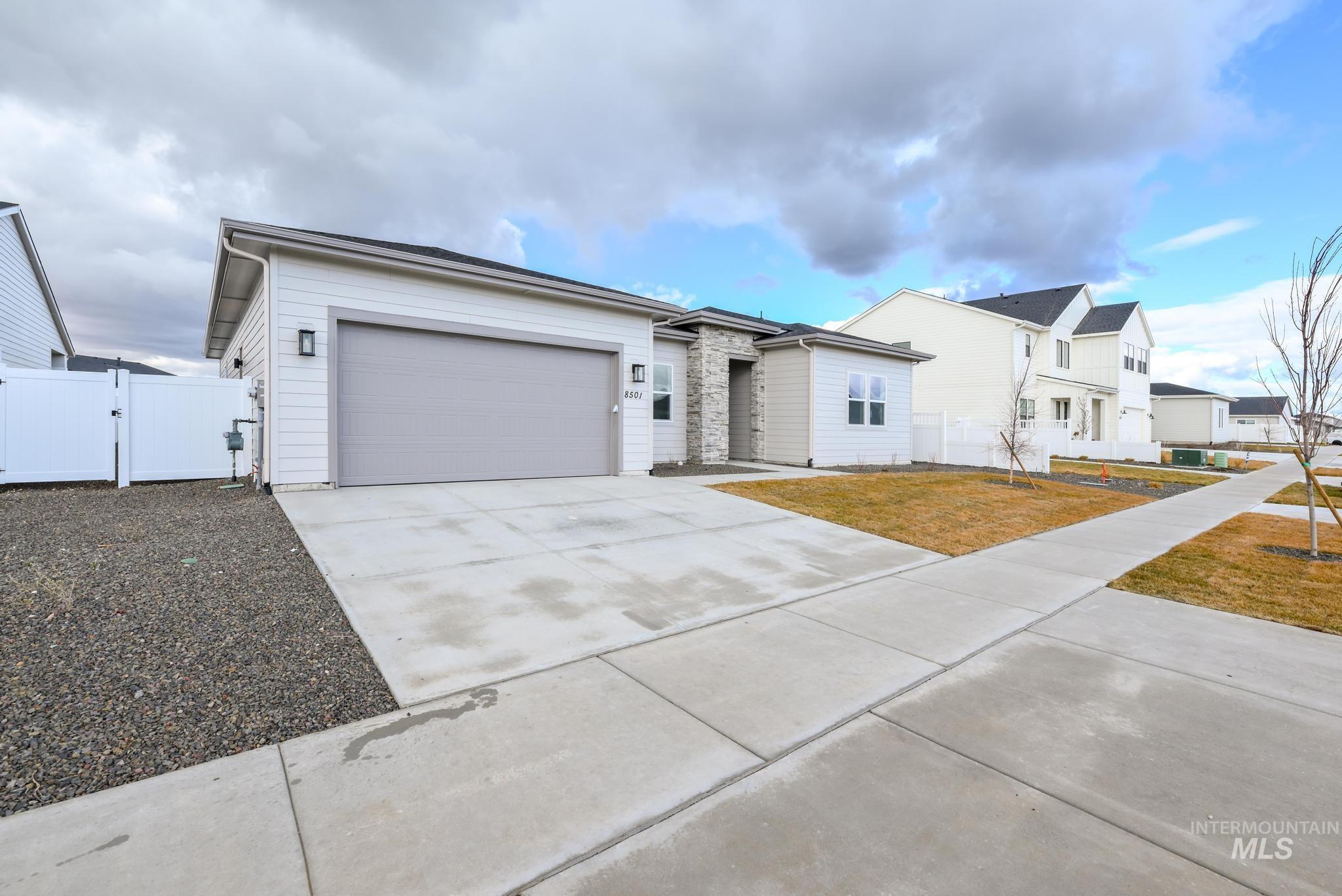 8501 South Country Wind Avenue Meridian, ID 83642 - Photo 2 of 39 View of front of house featuring a gate, driveway, and a garage