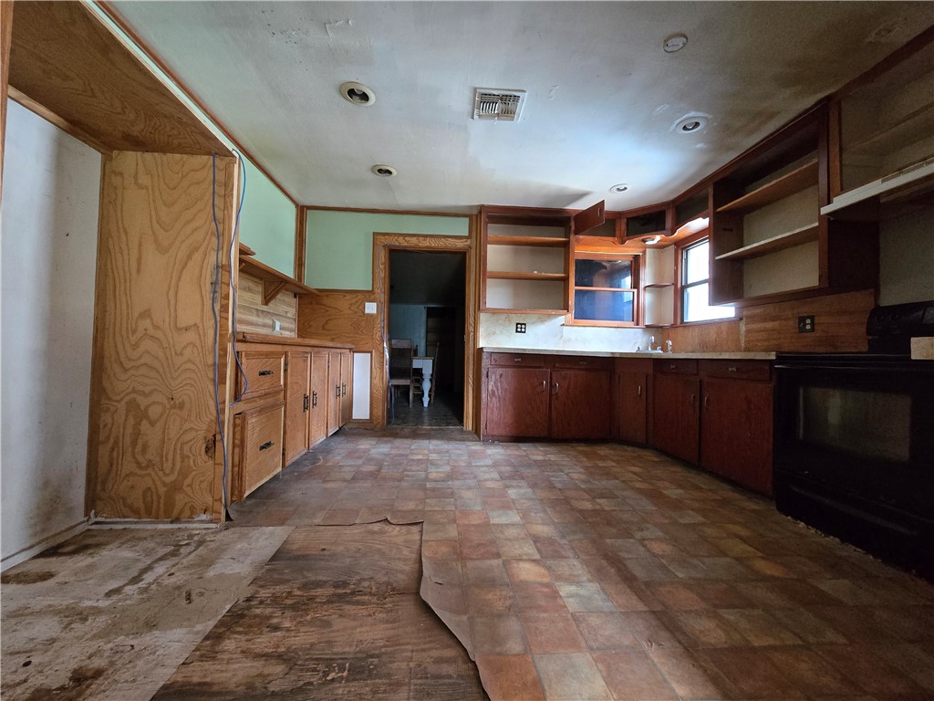 305 East Laredo Street Freer, TX 78357 - Photo 5 of 19 a large kitchen with stainless steel appliances granite countertop a refrigerator and a stove
