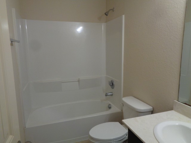 23314 Brat Pass Drive Spring, TX 77373 - Photo 16 of 20 a white toilet sitting next to a bath tub