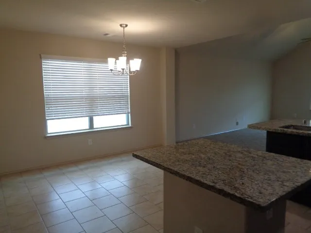 a kitchen with kitchen island a counter top space and a sink