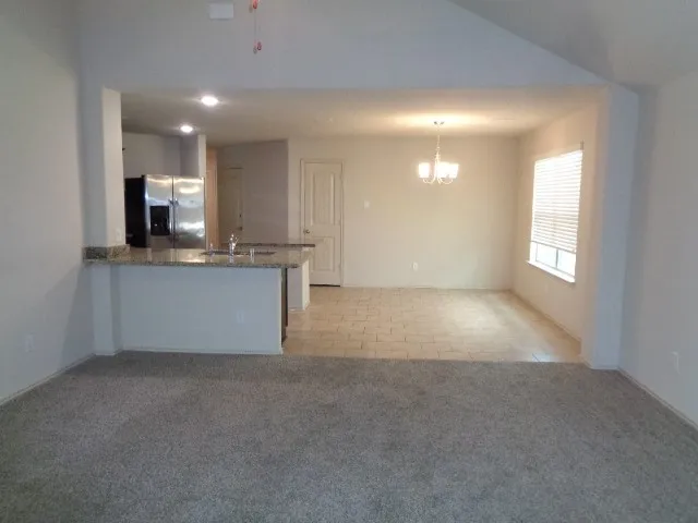 a view of a kitchen and a window in a room