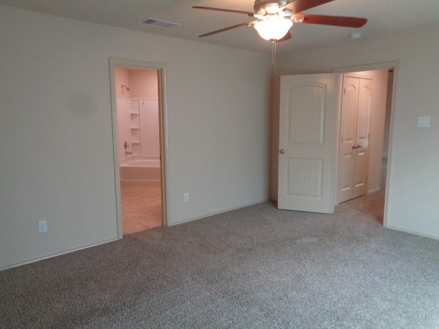 23314 Brat Pass Drive Spring, TX 77373 - Photo 8 of 20 an empty room with a chandelier fan and a window