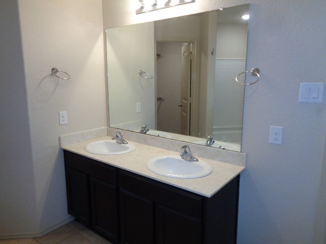 23314 Brat Pass Drive Spring, TX 77373 - Photo 10 of 20 a bathroom with a sink and a mirror