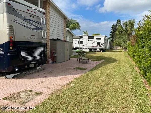 a view of a backyard with sitting area