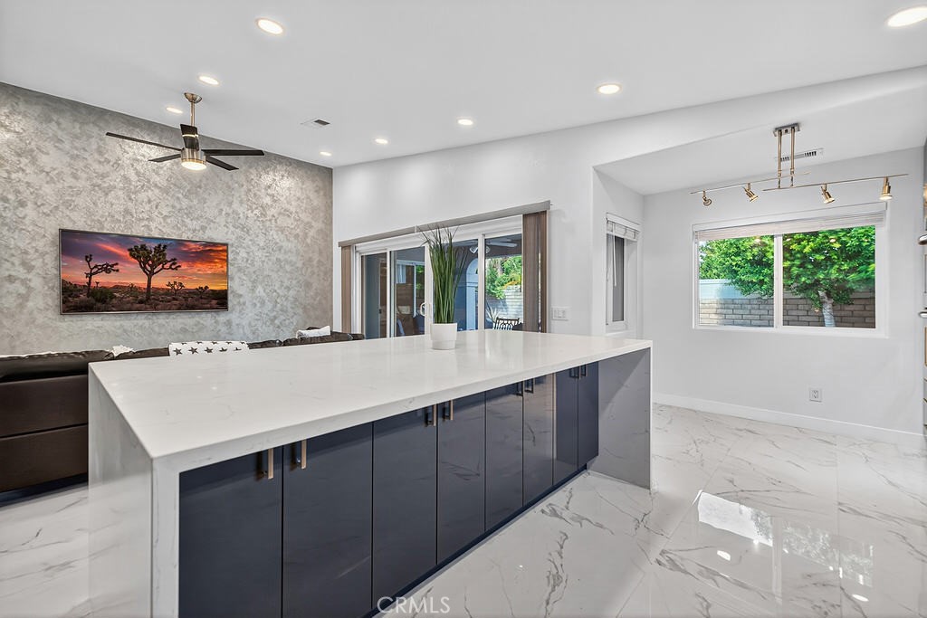 68830 Jarana Road Cathedral City, CA 92234 - Photo 11 of 28 a kitchen with kitchen island a sink window and chairs