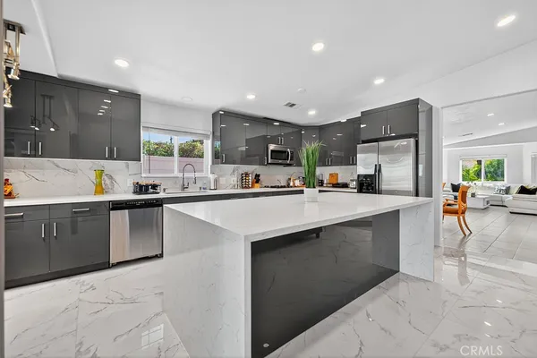 a kitchen with counter top space and appliances