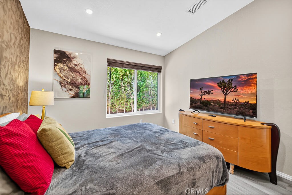 68830 Jarana Road Cathedral City, CA 92234 - Photo 18 of 28 a bedroom with a bed and a flat screen tv