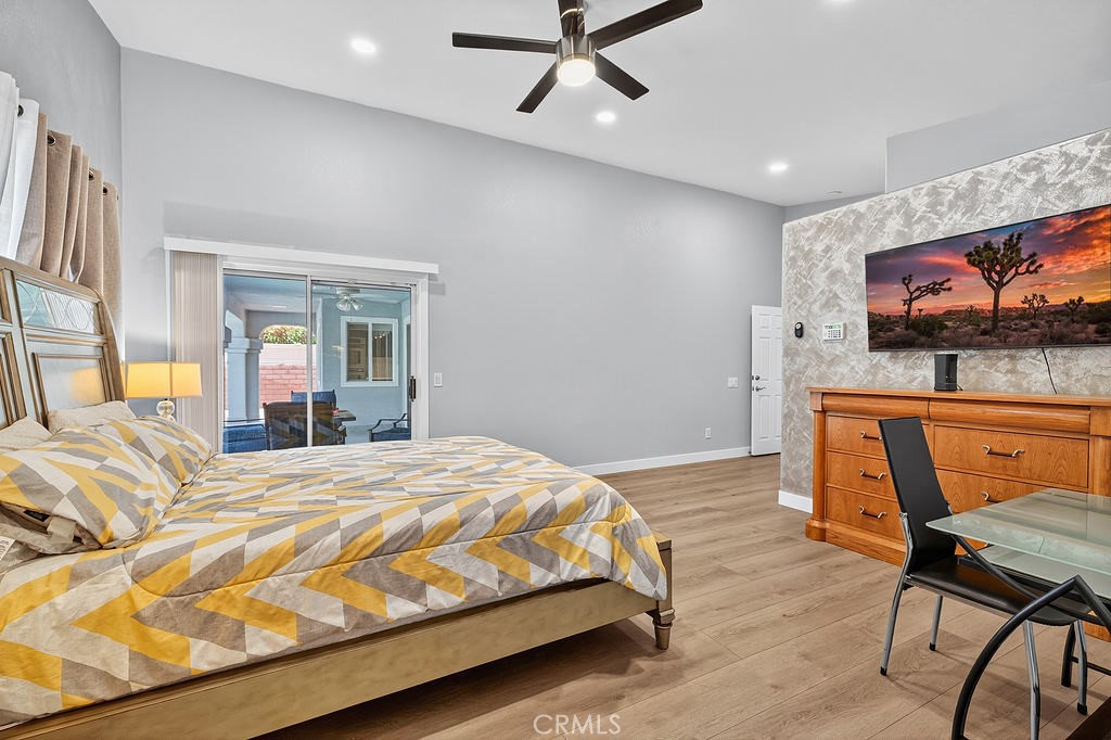 68830 Jarana Road Cathedral City, CA 92234 - Photo 22 of 28 a bedroom with a bed and wooden floor