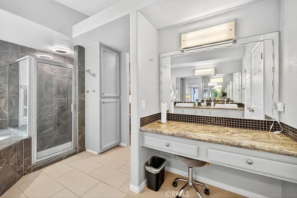 a bathroom with a granite countertop sink mirror and