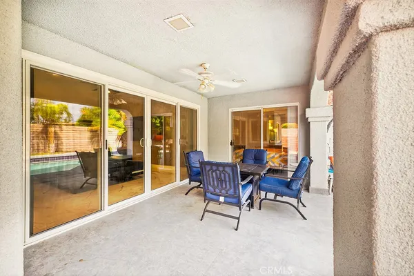 a dining room with furniture a chandelier and wooden floor