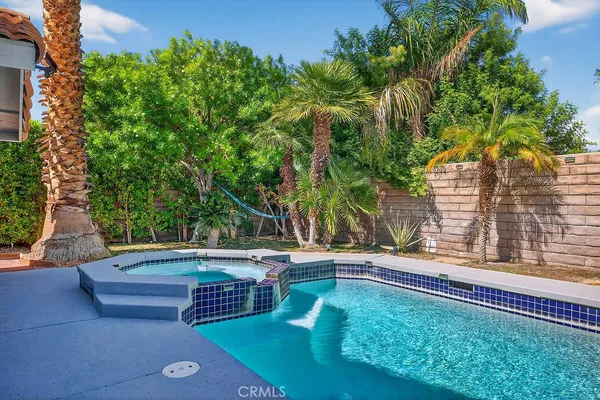 a view of backyard with swimming pool and outdoor seating