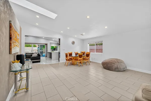 a living room with furniture and white chairs