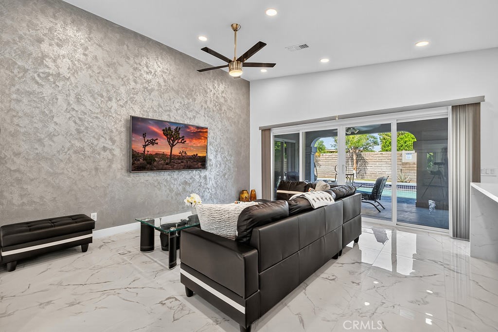 68830 Jarana Road Cathedral City, CA 92234 - Photo 8 of 28 a living room with furniture a flat screen tv and a floor to ceiling window