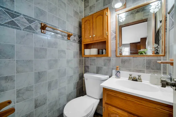 a bathroom with a sink a toilet and a mirror