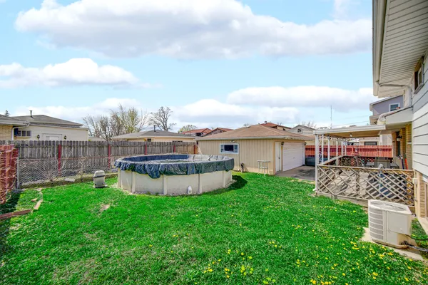 a view of a chairs and table in back yard of the house