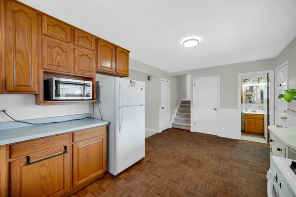a kitchen with cabinets and a refrigerator