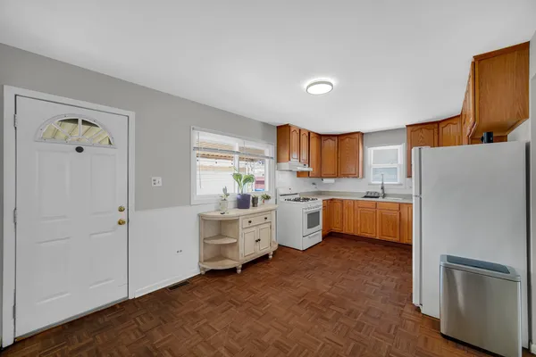 a kitchen with white cabinets and white appliances