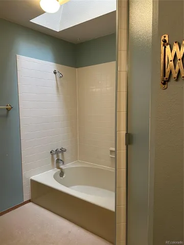 a bathroom with a tub and shower