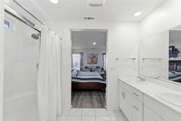 a en suite bathroom with a sink a mirror and a shower