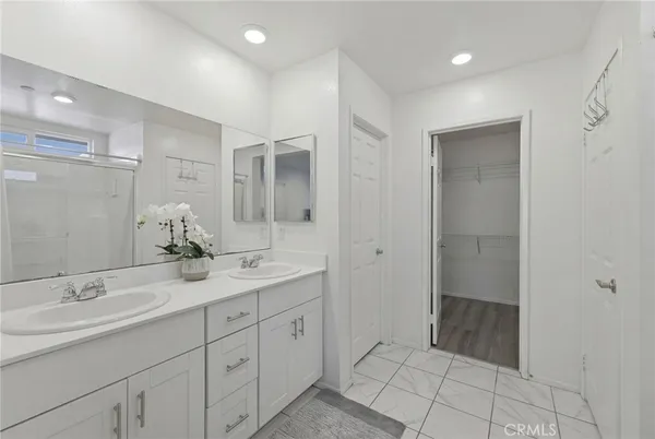 a spacious bathroom with a granite countertop sink a mirror and a shower