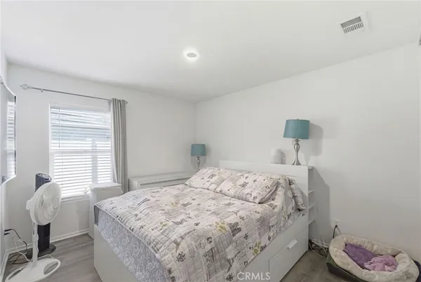 a bedroom with a bed and a chair