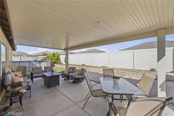 a patio with a table and chairs