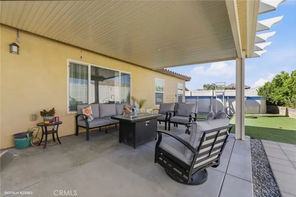 a living room with patio furniture and a garden
