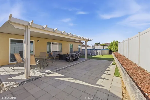 a view of house with backyard porch and seating space
