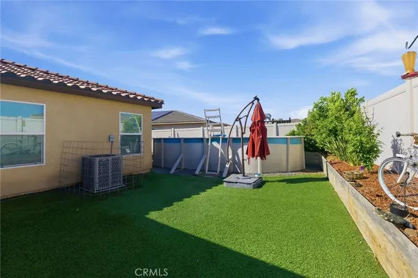 a view of an house with backyard space and porch