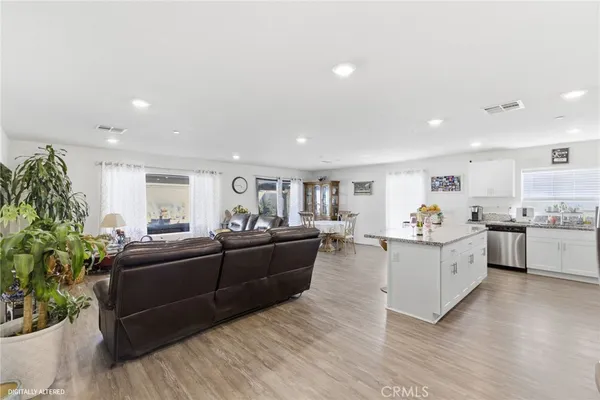 a living room with furniture and a kitchen