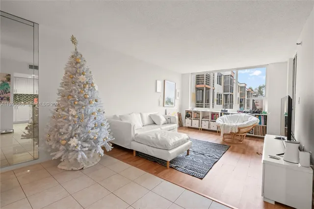 a living room with furniture a rug and a flat screen tv