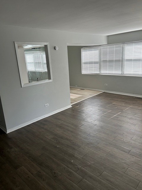 2186 North Oakbrook Circle, Unit 2186 Palatine, IL 60074 - Photo 5 of 11 a view of an empty room with a window and wooden floor