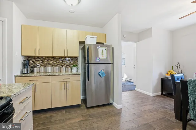 a kitchen with stainless steel appliances granite countertop a refrigerator and a stove