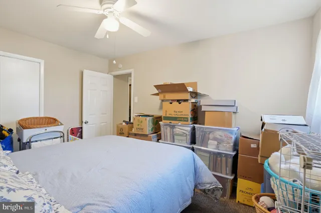a room with furniture a rug and a fan