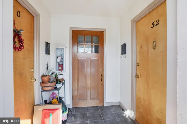 a living room with furniture and a dining table