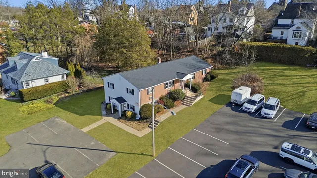 an aerial view of a house with garden space and street view