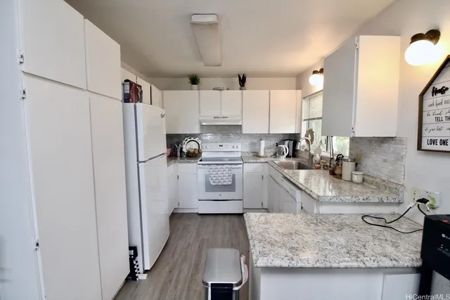 a kitchen with a sink stove and cabinets