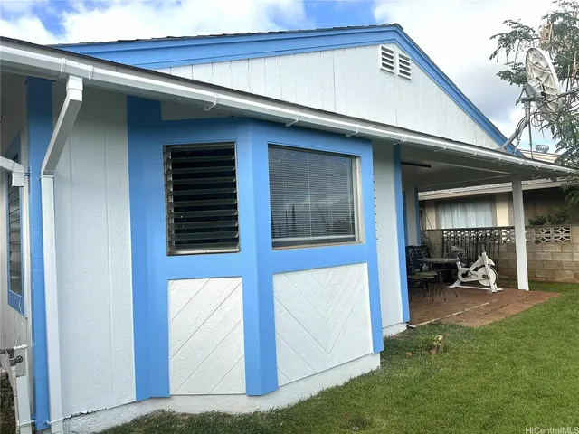 a living room with furniture a wooden floor and a chandelier