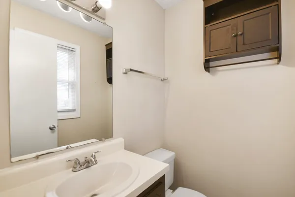 a bathroom with a sink a toilet and vanity